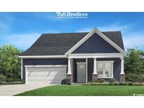 Charming single-story home featuring a blue exterior, well-manicured lawn, and a two-car garage at 13 Condor Ct, Pawleys Island, SC 29585