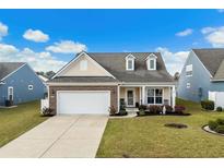 Charming single-story home featuring a well-manicured lawn and a two-car garage in a residential neighborhood at 2989 Ellesmere Circle, Myrtle Beach, SC 29579