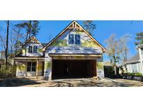 Under construction exterior featuring an attached two-car garage and the first glimpse of windows at 37 Winnowing Way, Pawleys Island, SC 29585