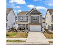 Charming two-story home with a well-maintained yard and a two-car garage at 511 Mcalister Dr., Little River, SC 29566
