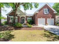 Charming brick home with a well-manicured lawn and inviting curb appeal at 728 Camden Circle, Pawleys Island, SC 29585