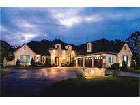 Stately brick home at night features a circular driveway and manicured lawn at 110 Highwood Circle, Murrells Inlet, SC 29576