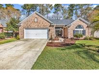 Charming brick home features a well-manicured lawn and a two-car garage, blending comfort with curb appeal at 1151 N Blackmoor Dr., Murrells Inlet, SC 29576