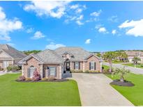 Beautiful brick home featuring a well manicured lawn and a spacious driveway at 169 Kessinger Dr., Surfside Beach, SC 29575