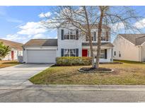 Charming two-story home with a well-maintained lawn, attached garage, and red front door at 2629 Scarecrow Way, Myrtle Beach, SC 29579