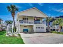 Charming two-story beach house with a spacious front deck and ground floor garage at 325 52Nd Ave. N, North Myrtle Beach, SC 29582