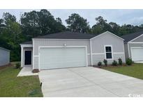Charming single-Gathering home features a one car garage and manicured front yard at 362 Ladyfish Loop, Sunset Beach, NC 28468