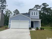 Charming single-Gathering home with a two-car garage and a well-maintained lawn at 382 Ladyfish Loop, Sunset Beach, NC 28468