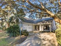 Charming home with a two-car garage, lush landscaping and a large shade tree in a desirable location at 414 Dornoch Dr., Pawleys Island, SC 29585