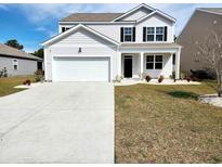Charming two-story home with a two car garage, well-manicured lawn, and black shutters at 5088 Wavering Place Loop, Myrtle Beach, SC 29579