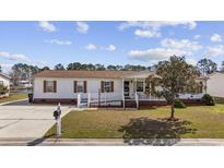 Charming single-story home with a well-maintained lawn and inviting front porch at 6630 Breezewood Blvd., Myrtle Beach, SC 29588