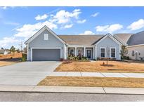 Charming single-story home with a well-manicured lawn, attached two-car garage, and inviting front porch at 7375 Sarteano Dr., Myrtle Beach, SC 29572