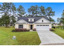 Charming single-story home featuring a well-manicured lawn and attached two-car garage at 800 Stone Pine Ct., Loris, SC 29569