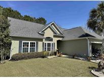 Charming single-story home features a well-manicured lawn and tidy landscaping for a welcoming curb appeal at 1210 Pecan Grove Blvd., Conway, SC 29527