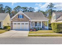 Charming home featuring a stone facade, a well-manicured lawn, and an attached two-car garage at 1309 Suncrest Dr., Myrtle Beach, SC 29577