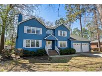 Charming two-story home with a manicured lawn, white trim, and an attached two-car garage at 138 Wofford Rd., Conway, SC 29526