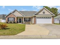 Charming single-story home with brick and siding, a well-manicured lawn, and an attached two car garage at 171 Talon Dr., Conway, SC 29527
