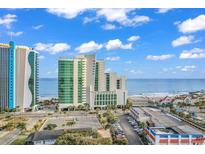 Beautiful exterior view of the condo building with beach views on a sunny day at 201 South Ocean Blvd. # 1604, Myrtle Beach, SC 29577