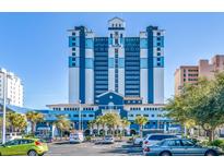 Striking multi-story blue and white condo building with covered entry and ample parking at 2201 S Ocean Blvd. # 1803, Myrtle Beach, SC 29577
