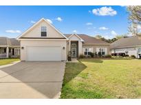Charming single Gathering home with a well manicured lawn and a two-car garage on a sunny day at 231 Jessica Lakes Dr., Conway, SC 29526