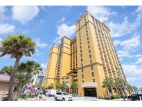 Stunning view of yellow building with palm trees and blue sky in a tropical setting at 2600 N Ocean Blvd. # 1914, Myrtle Beach, SC 29577