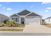 Charming single-Gathering home featuring a two-car garage, landscaped front yard, and welcoming entryway at 2848 Ophelia Way, Myrtle Beach, SC 29577
