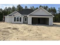 Charming one-story home with grey siding, black roof, and an attached two-car garage at 2921 Hughes Gasque Rd., Aynor, SC 29511