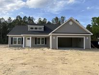 Beautiful single-story home with gray siding, black shutters, and an attached two-car garage at 2925 Hughes Gasque Rd., Aynor, SC 29511