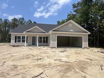Newly constructed single-story home featuring a two-car garage, neutral siding, and classic architectural details at 2929 Hughes Gasque Rd., Aynor, SC 29511