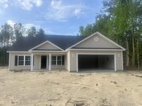 Charming single-story home features a spacious two-car garage and manicured landscaping at 2929 Hughes Gasque Rd., Aynor, SC 29511