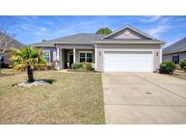 Charming single-story home with a well-manicured lawn and a two-car attached garage at 321 Galway Ct., Longs, SC 29568