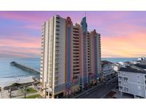 Stunning oceanfront building with a pier and colorful Art Deco facade, offering breathtaking views at 3500 N Ocean Blvd. # 902, North Myrtle Beach, SC 29582