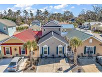 Charming colorful homes with diverse metal roofs and well-maintained landscaping offers a unique community aesthetic at 4350 Grande Harbour Blvd., Little River, SC 29566