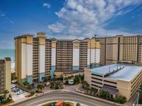 Expansive exterior view of Beach Cove Resort, showcasing its multi-story design and proximity to the ocean at 4800 S Ocean Blvd. # 1418, North Myrtle Beach, SC 29582