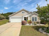 Charming home featuring a 1-car garage and meticulously landscaped front yard at 511 Mattamushkeet Dr., Little River, SC 29566