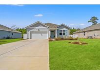 Charming single-story home with manicured lawn, attached garage, and inviting front porch at 515 Goldstar St., Conway, SC 29526