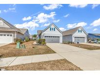 Charming home exterior featuring well-manicured lawns and attached garages on a sunny day at 6037 Campanella St., Myrtle Beach, SC 29577