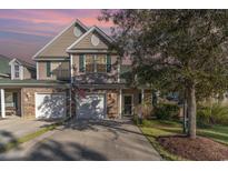 Charming two-story home with a two-car garage and well-maintained landscaping and green shutters at 611 Indigo Bunting Ln. # 42 E, Murrells Inlet, SC 29576