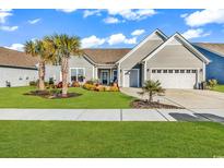 Charming single-story home featuring a well-manicured lawn, landscaped flower beds, and a two-car garage at 7205 Spoleto Dr., Myrtle Beach, SC 29572