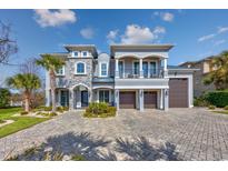Stately two-story home featuring a paver driveway and a balcony overlooking the front yard at 900 Waterside St., North Myrtle Beach, SC 29582