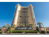 Stunning exterior view of beachfront condo building with lush landscaping and iconic 'Maisons-sur-Mer' sign at 9650 Shore Dr. # 304, Myrtle Beach, SC 29572