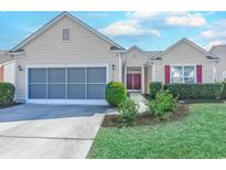 Charming single-story home featuring well-manicured landscaping and a two-car garage at 1017 Meadowlands Trail, Calabash, NC 28467