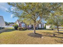 Charming brick home with well-maintained landscaping and a welcoming front yard at 133 Hartwell Dr., Little River, SC 29566
