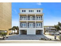 A beautiful three-story beach house with multiple balconies and covered parking at 1605 Ocean Blvd. S, North Myrtle Beach, SC 29582