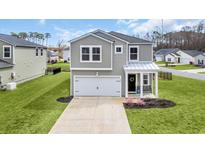 Charming two-story home with grey siding, white trim, two car garage, and manicured lawn at 204 Leaflet Loop, Pawleys Island, SC 29585