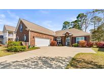 Charming brick home featuring a spacious driveway and attached two-car garage at 3108 Byrom Rd., Myrtle Beach, SC 29579