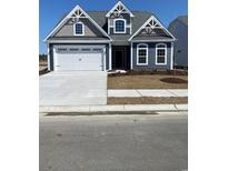 Charming two-story home with a well-manicured lawn, white garage door, and decorative gable accents at 340 Broughton Dr., Myrtle Beach, SC 29579