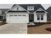 Charming home featuring a two-car garage, white siding, and a modern black trimmed roof at 390 Starlit Way, Myrtle Beach, SC 29579