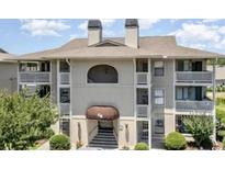Well-maintained condo building featuring classic architecture, landscaped grounds, and a covered entryway at 4242 Pinehurst Circle # N4, Little River, SC 29566