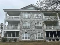 Condo exterior showcasing the light gray brick facade and multiple balconies at 4639 Wild Iris Dr. # 43-204, Myrtle Beach, SC 29577